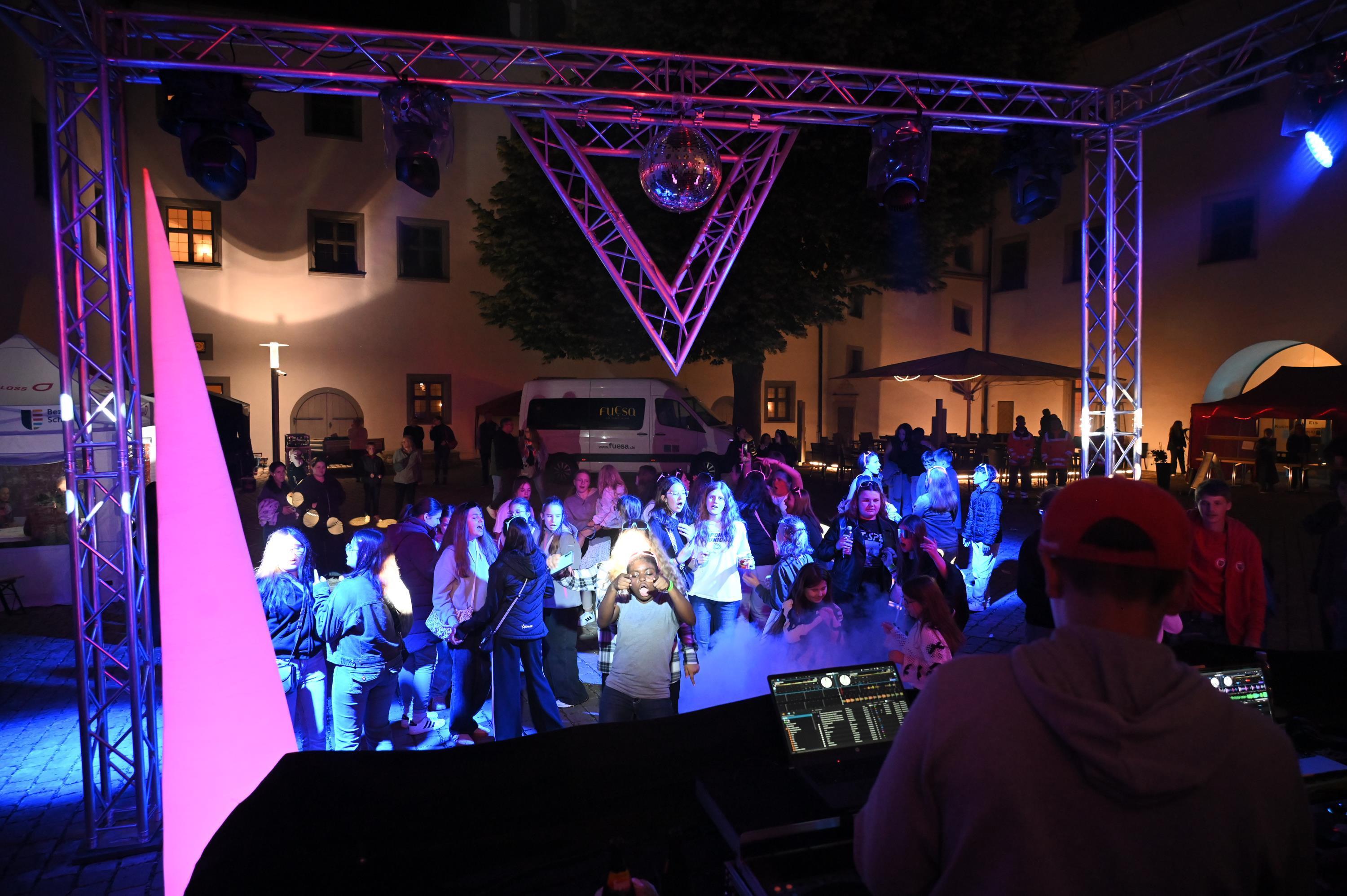 Tänzerinnen und Tänzer mit Discobeleuchtung